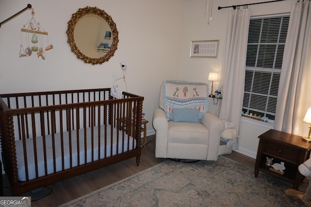 2566 Summit Cove Dr, Duluth, GA 30097 - bedroom featuring wood finished floors, baseboards, and a nursery area