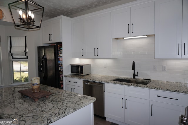 2566 Summit Cove Dr, Duluth, GA 30097 - kitchen featuring stainless steel appliances, a sink, white cabinets, a chandelier, and decorative backsplash