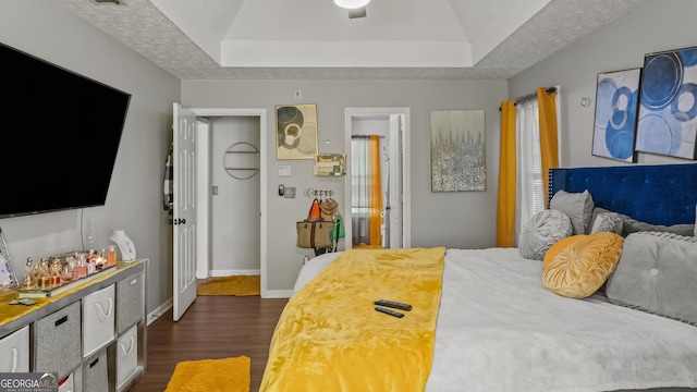 1401 Aberdeen Ct, Mcdonough, GA 30253 - bedroom with baseboards, a raised ceiling, and dark wood-type flooring