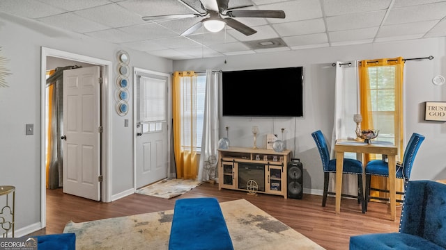 1401 Aberdeen Ct, Mcdonough, GA 30253 - living room featuring wood finished floors, baseboards, ceiling fan, and a drop ceiling