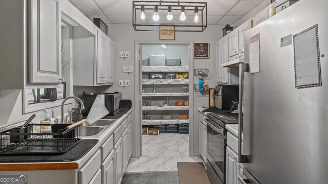 1401 Aberdeen Ct, Mcdonough, GA 30253 - kitchen featuring a drop ceiling, appliances with stainless steel finishes, marble finish floor, under cabinet range hood, and white cabinetry