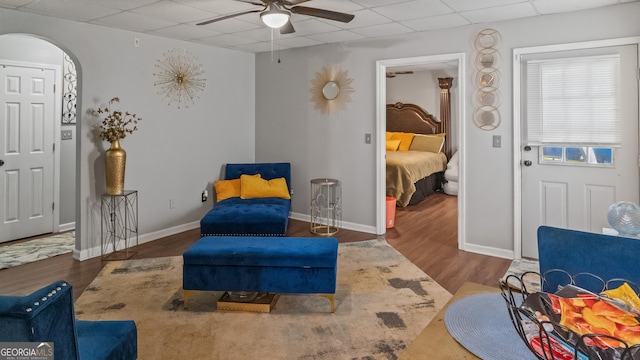 1401 Aberdeen Ct, Mcdonough, GA 30253 - sitting room featuring arched walkways, a ceiling fan, baseboards, a drop ceiling, and wood finished floors