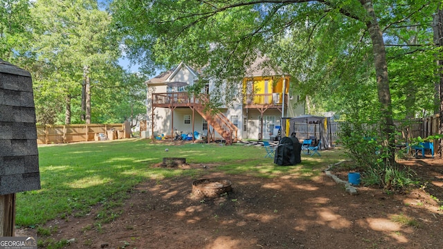1401 Aberdeen Ct, Mcdonough, GA 30253 - rear view of property with a lawn, a wooden deck, a fenced backyard, an outdoor fire pit, and stairs