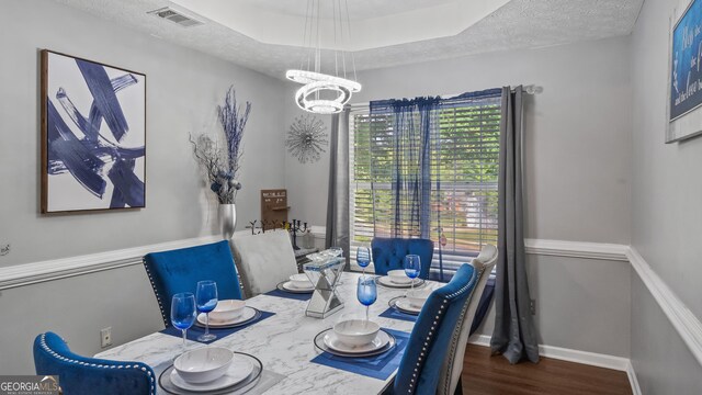 1401 Aberdeen Ct, Mcdonough, GA 30253 - dining room featuring an inviting chandelier, plenty of natural light, wood finished floors, and visible vents