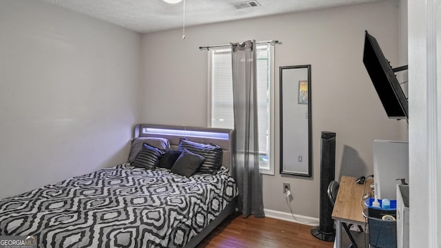 1401 Aberdeen Ct, Mcdonough, GA 30253 - bedroom with baseboards, visible vents, a textured ceiling, and dark wood-type flooring