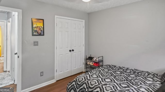 1401 Aberdeen Ct, Mcdonough, GA 30253 - bedroom featuring a closet, a ceiling fan, baseboards, and wood finished floors