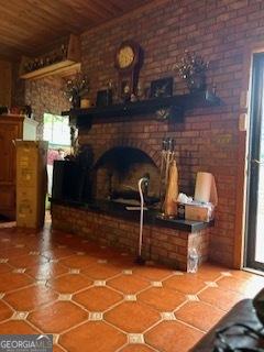 376 Paoli Rd, Carlton, GA 30627 - tiled living area with wood ceiling and brick wall
