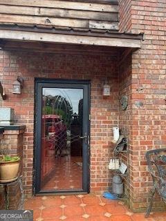 376 Paoli Rd, Carlton, GA 30627 - view of exterior entry featuring brick siding