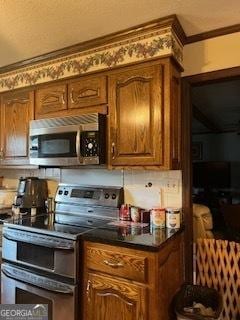 bar with stainless steel appliances and ornamental molding