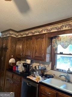 kitchen featuring a textured ceiling, dishwashing machine, and a sink