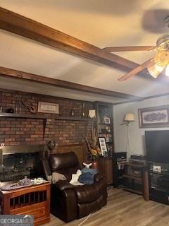 living area featuring a fireplace, wood finished floors, and ceiling fan