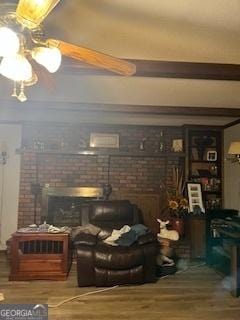 living area with wood finished floors and a fireplace