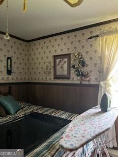 376 Paoli Rd, Carlton, GA 30627 - bedroom featuring ornamental molding, wainscoting, and wallpapered walls