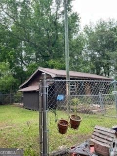 view of yard with fence and an outbuilding