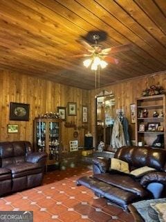 living room featuring wooden walls, tile patterned flooring, wooden ceiling, and ceiling fan