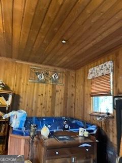 interior space featuring wooden walls and wood ceiling
