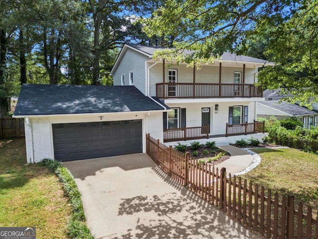 view of front of property with a garage, fence, a balcony, brick siding, and a porch