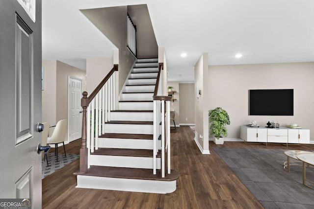 staircase with baseboards, recessed lighting, and wood finished floors