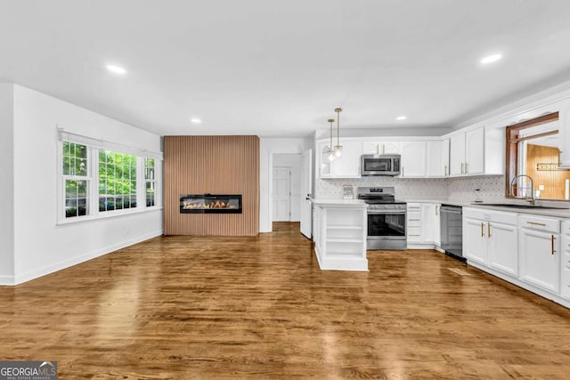 276 Greentree Pkwy, Macon, GA 31220 - kitchen with dark wood-type flooring, recessed lighting, white cabinets, a sink, and appliances with stainless steel finishes