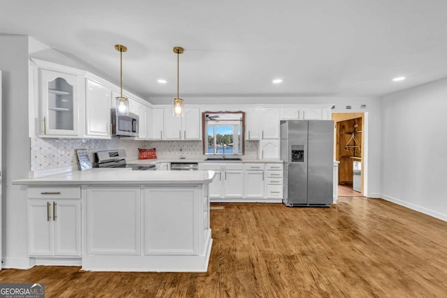 276 Greentree Pkwy, Macon, GA 31220 - kitchen featuring appliances with stainless steel finishes, a sink, light countertops, white cabinetry, and tasteful backsplash