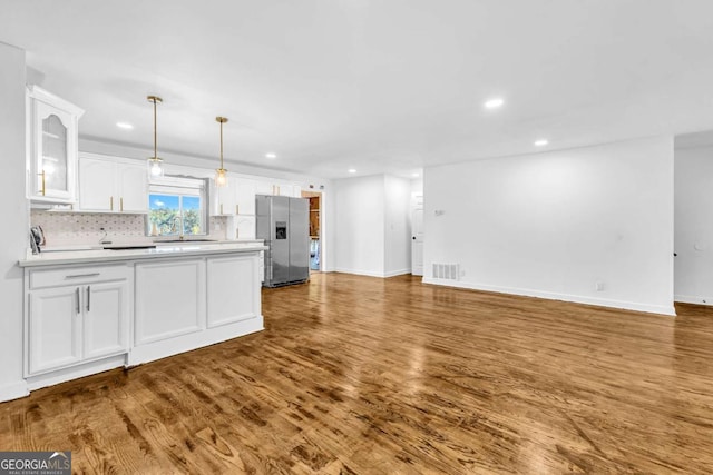 276 Greentree Pkwy, Macon, GA 31220 - kitchen with stainless steel refrigerator with ice dispenser, open floor plan, visible vents, and white cabinetry