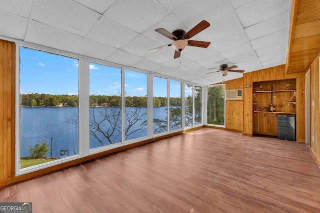 276 Greentree Pkwy, Macon, GA 31220 - unfurnished sunroom featuring wood walls, wood finished floors, a paneled ceiling, a water view, and a wall unit AC