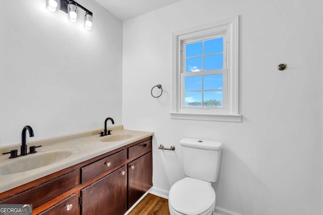 276 Greentree Pkwy, Macon, GA 31220 - bathroom with double vanity, toilet, baseboards, and a sink