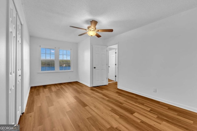 276 Greentree Pkwy, Macon, GA 31220 - unfurnished bedroom featuring a textured ceiling, baseboards, a ceiling fan, and light wood-type flooring