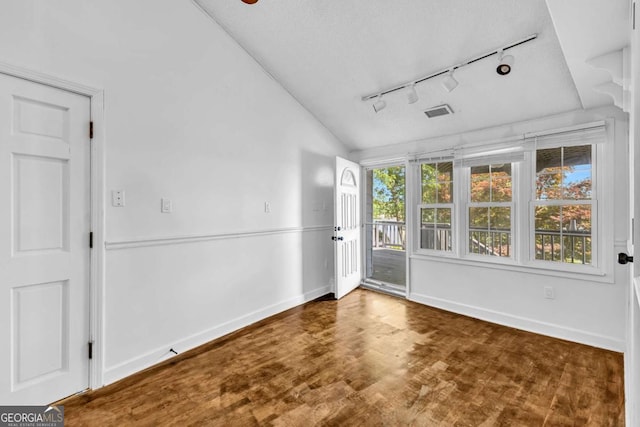 276 Greentree Pkwy, Macon, GA 31220 - unfurnished room with rail lighting, vaulted ceiling, baseboards, and wood finished floors
