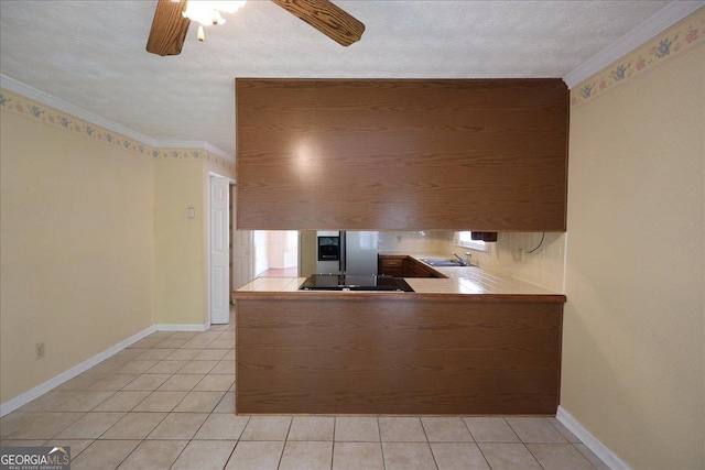 kitchen with stainless steel fridge, black stovetop, ceiling fan, and light tile patterned flooring
