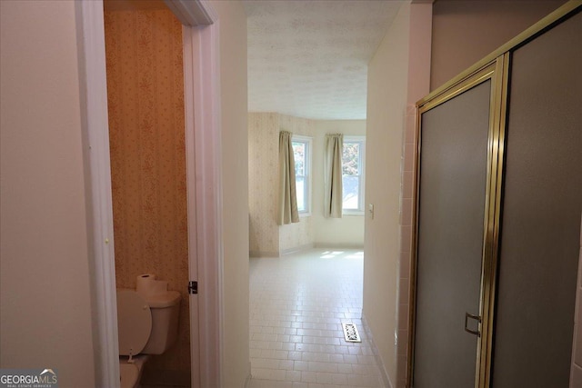 hallway with wallpapered walls