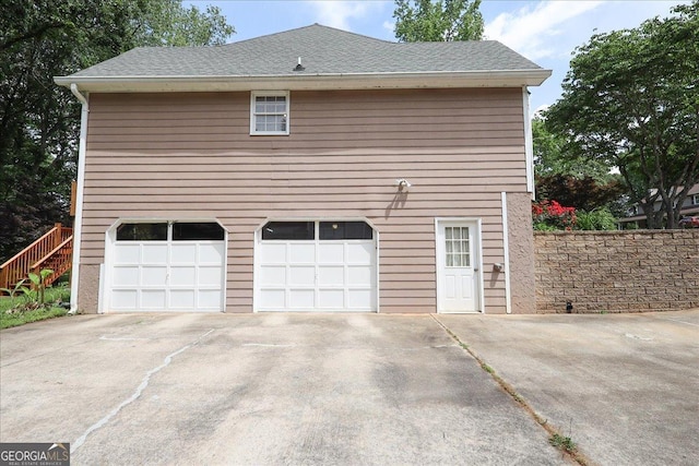 garage featuring concrete driveway