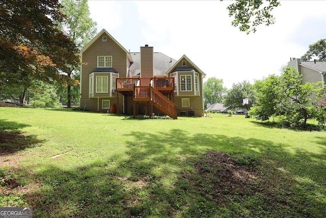 back of house featuring a yard, a deck, a chimney, and stairs