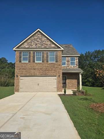 5705 Laney Dr, Rex, GA 30273 - view of front of house with driveway, a front lawn, brick siding, and an attached garage