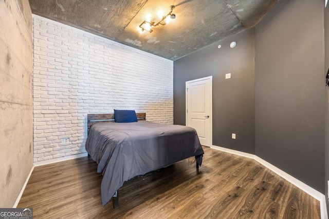 400 W Peachtree St NW Unit 3614, Atlanta, GA 30308 - bedroom featuring baseboards, wood finished floors, and brick wall