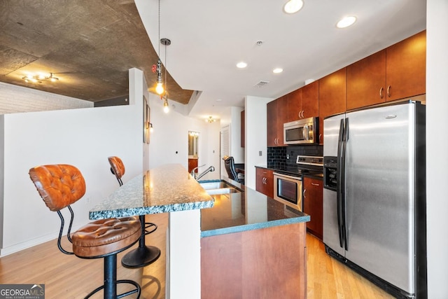 400 W Peachtree St NW Unit 3614, Atlanta, GA 30308 - kitchen with recessed lighting, decorative backsplash, appliances with stainless steel finishes, light wood finished floors, and a sink