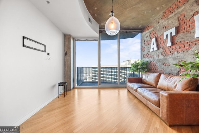 400 W Peachtree St NW Unit 3614, Atlanta, GA 30308 - living room featuring visible vents, a wall of windows, wood finished floors, and baseboards