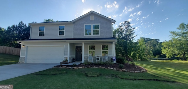 traditional-style house with a porch, a front yard, concrete driveway, an attached garage, and fence
