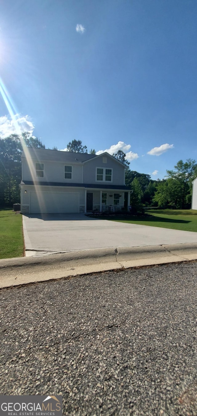 traditional-style house with concrete driveway