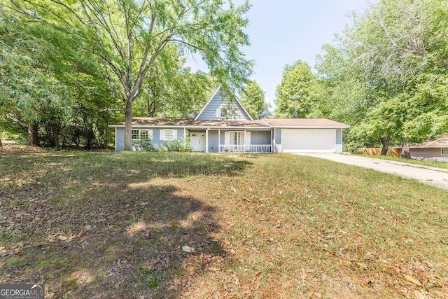 view of front of home with a porch, a garage, a front yard, and concrete driveway