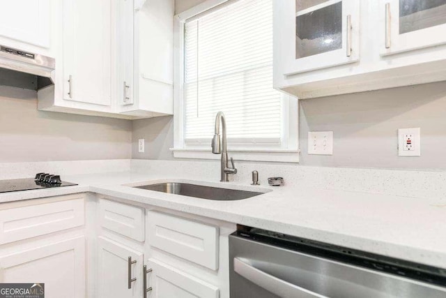 kitchen with a sink, dishwasher, white cabinets, and glass insert cabinets