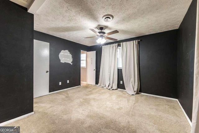 unfurnished bedroom with baseboards, carpet flooring, and a textured ceiling