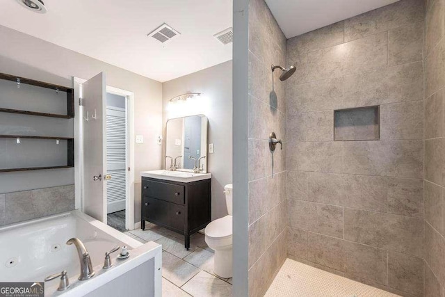 full bathroom featuring vanity, toilet, a tub with jets, visible vents, and tiled shower