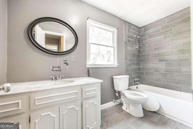 full bathroom with vanity,  shower combination, baseboards, and toilet