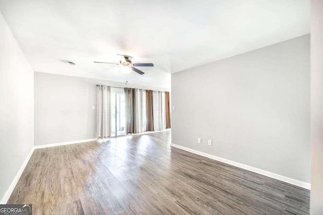 unfurnished room featuring baseboards, ceiling fan, and wood finished floors