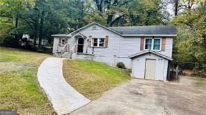 33 Stratford Dr NW, Atlanta, GA 30311 - view of front of home with an outbuilding, a front yard, aphalt driveway, and a shed