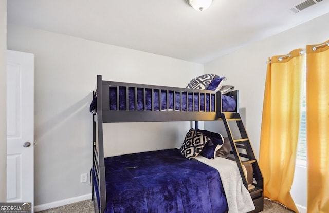 carpeted bedroom featuring visible vents and baseboards