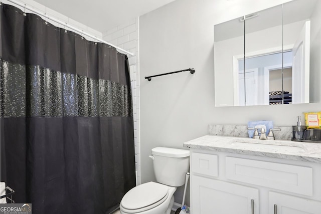 full bathroom with vanity, toilet, and curtained shower