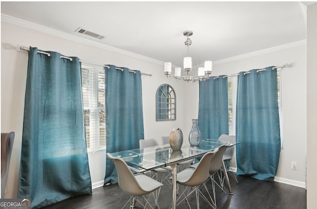 dining area with crown molding, visible vents, baseboards, an inviting chandelier, and wood finished floors