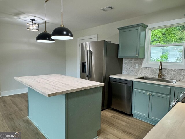 101 Newsome St, Union Point, GA 30669 - kitchen with dishwasher, a sink, wood counters, decorative backsplash, and light wood-style floors